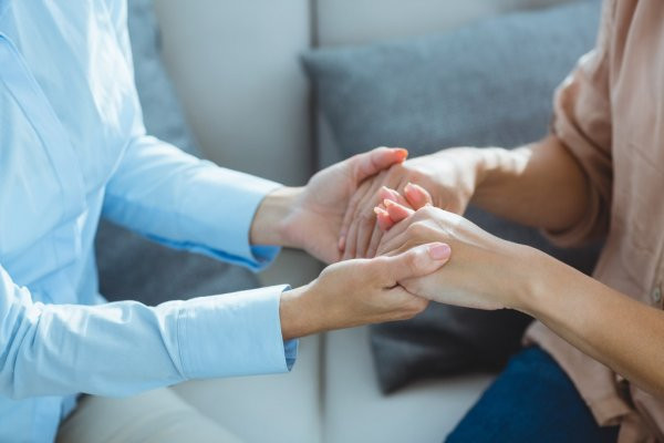 Depositphotos 114907320 stock photo therapist holding patient hands